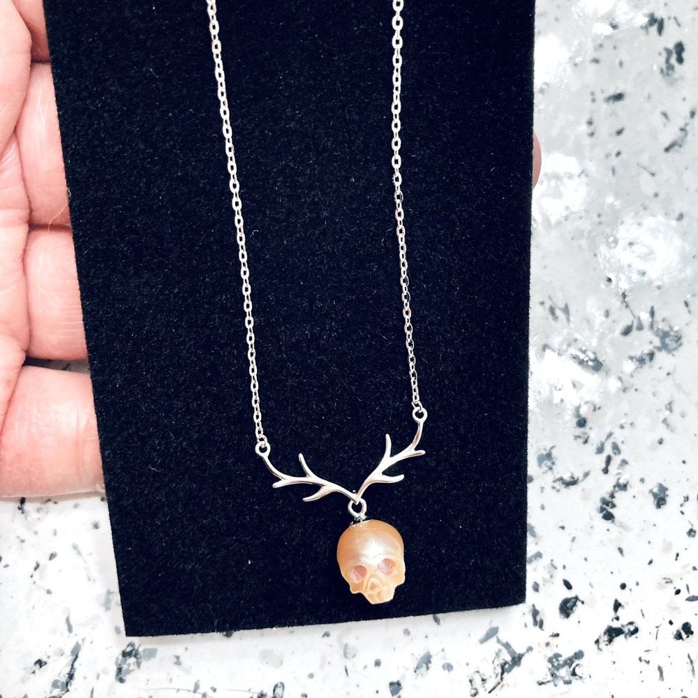 Carved pearl skull necklace
